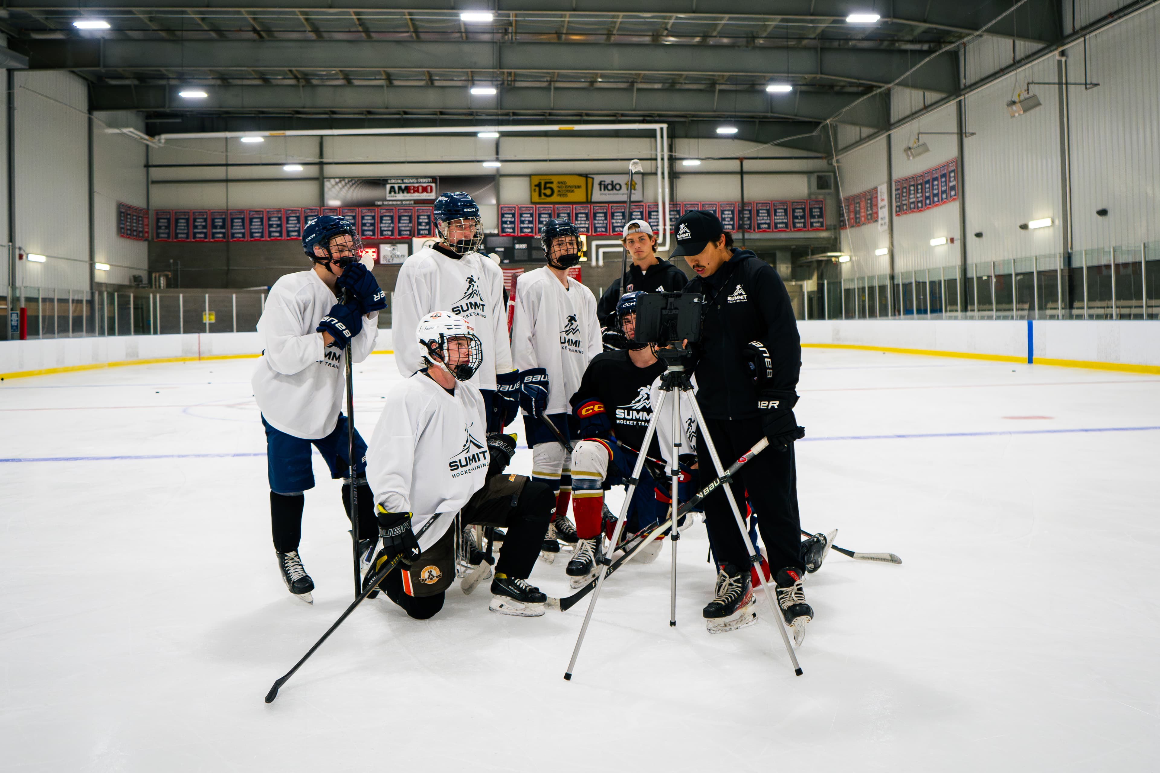 Summit Hockey players reviewing video during an on-ice session